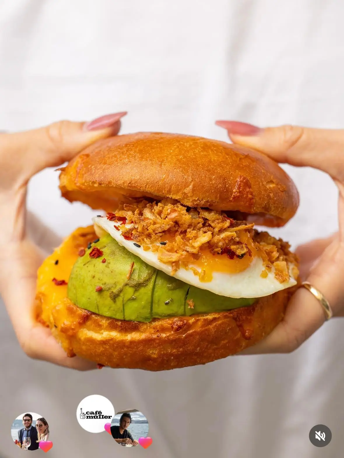 Egg burger with avocado and crispy onions in brioche